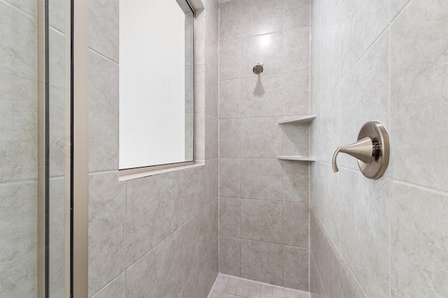 full bathroom with tiled shower