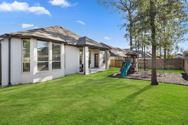 view of yard featuring a playground and a fenced backyard