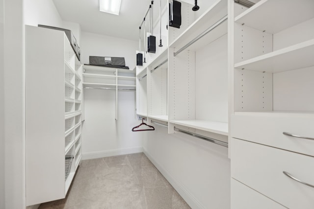 spacious closet featuring light carpet