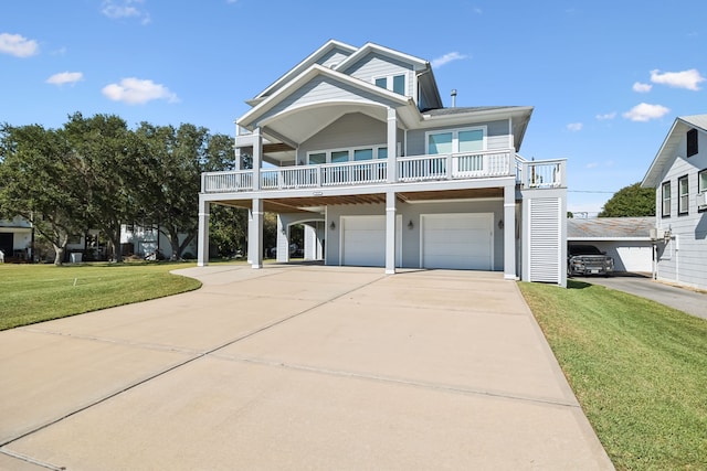 raised beach house with driveway, an attached garage, and a front lawn