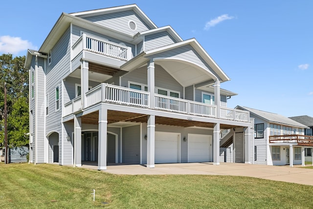 raised beach house with driveway, an attached garage, and a front yard