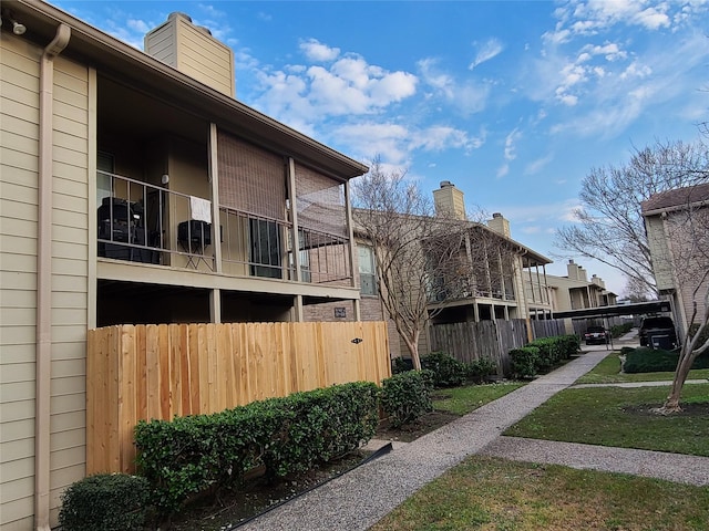 exterior space with a chimney and fence