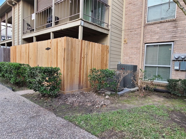 view of property exterior featuring central AC and brick siding