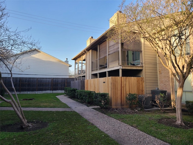 view of yard with fence and central AC