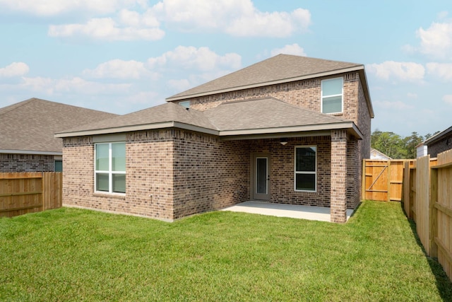 rear view of property with a patio, a fenced backyard, brick siding, a lawn, and roof with shingles