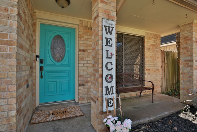 view of exterior entry with brick siding