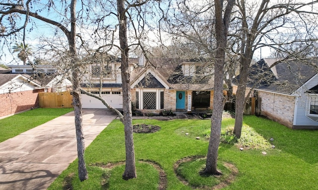 view of front of property featuring a garage, fence, a front lawn, and concrete driveway