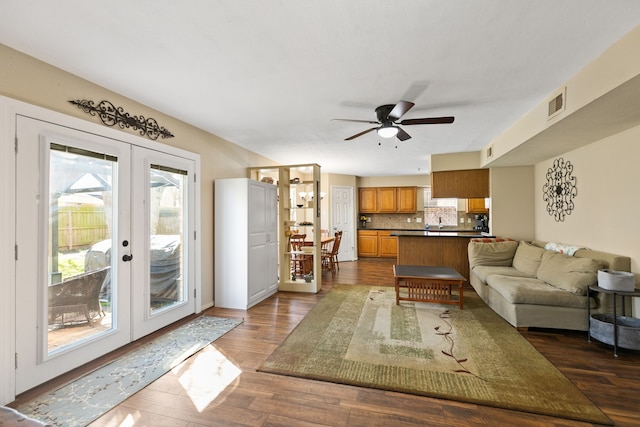 living room with ceiling fan, french doors, dark wood-type flooring, and visible vents