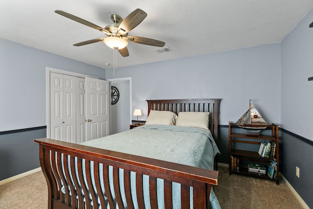 bedroom featuring baseboards, visible vents, a ceiling fan, carpet flooring, and a closet