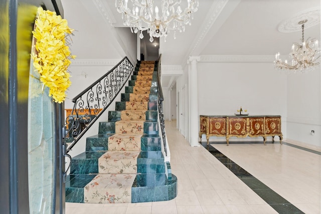 foyer with an inviting chandelier, stairs, crown molding, and tile patterned floors