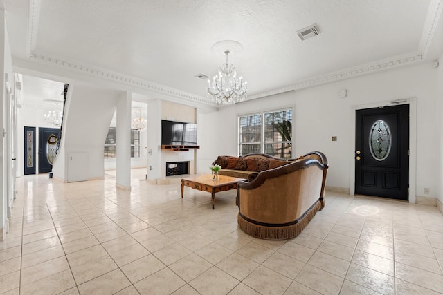 living room featuring visible vents, a notable chandelier, a fireplace with raised hearth, and light tile patterned flooring