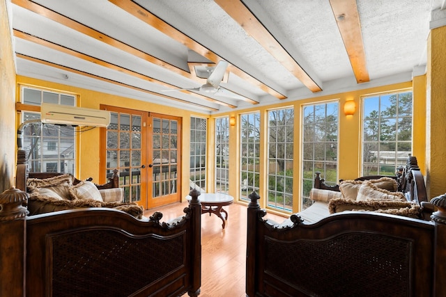 sunroom with a wall unit AC, french doors, a wealth of natural light, and beamed ceiling