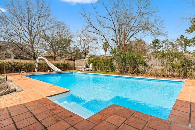 view of pool with a fenced in pool, a water slide, a fenced backyard, and a patio