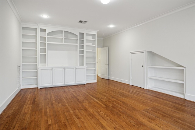 interior space with baseboards, visible vents, crown molding, and wood finished floors