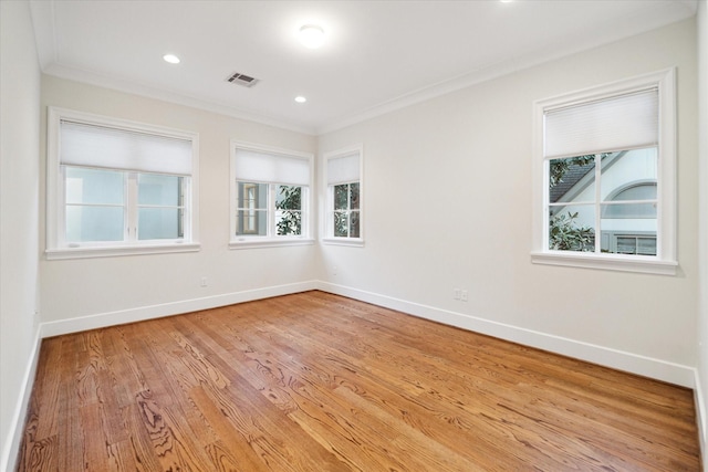 spare room featuring ornamental molding, visible vents, and baseboards