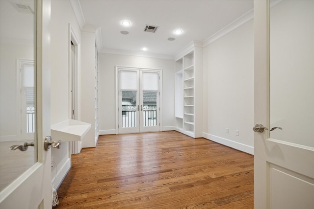 unfurnished room with visible vents, ornamental molding, french doors, light wood-type flooring, and recessed lighting