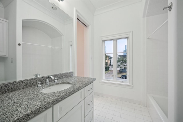 full bath featuring crown molding, shower / bath combination, vanity, baseboards, and tile patterned floors