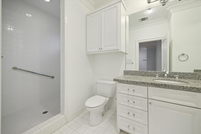 bathroom with toilet, visible vents, baseboards, a tile shower, and tile patterned floors