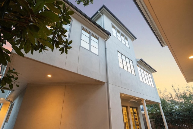 view of side of home with stucco siding