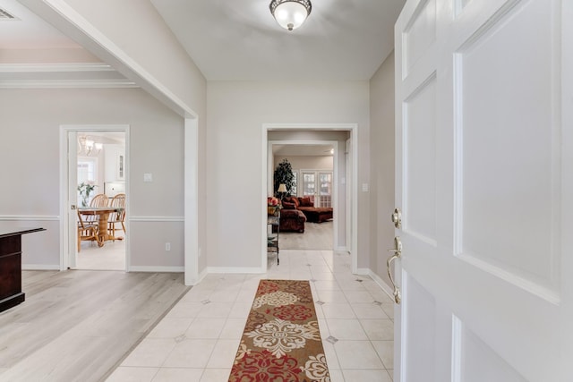 entrance foyer with light tile patterned floors, visible vents, and baseboards