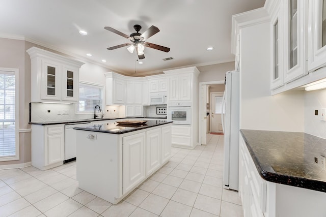 kitchen with white appliances, visible vents, a sink, and light tile patterned floors