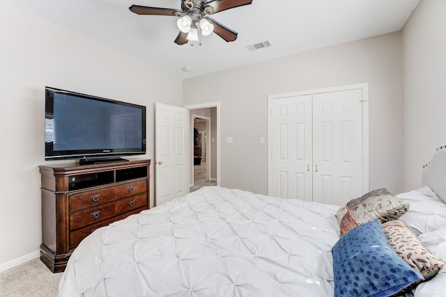 bedroom featuring ceiling fan, carpet flooring, visible vents, baseboards, and a closet