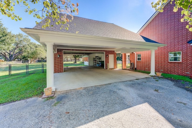 exterior space featuring a carport, fence, and a gate