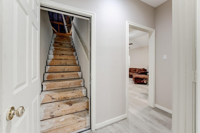 stairs featuring baseboards and wood finished floors