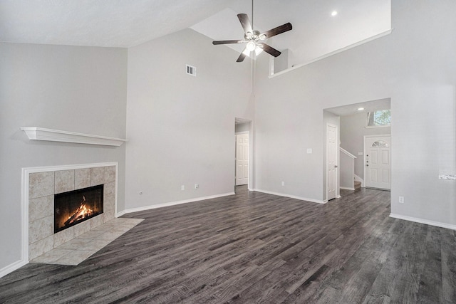 1911 Arrow Star Ct, Katy, TX 77493 - unfurnished living room featuring ceiling fan, dark wood-style floors, a fireplace, and high vaulted ceiling