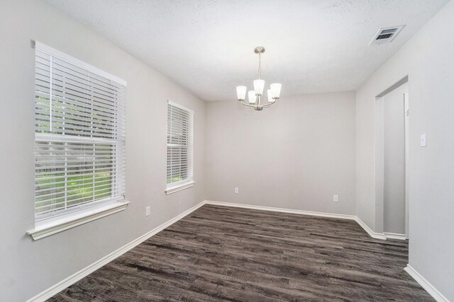 1911 Arrow Star Ct, Katy, TX 77493 - empty room with dark wood-style flooring and a chandelier