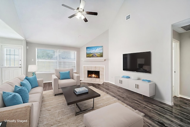 1911 Arrow Star Ct, Katy, TX 77493 - living area featuring wood finished floors, ceiling fan, high vaulted ceiling, and a tiled fireplace