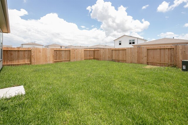 view of yard with a fenced backyard