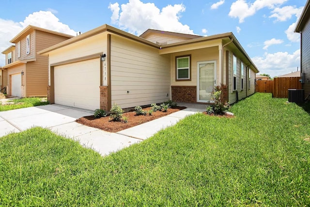 view of front of home featuring an attached garage, fence, a front lawn, central AC, and brick siding