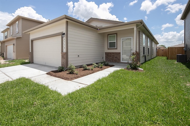 view of side of property with brick siding, a yard, fence, a garage, and cooling unit