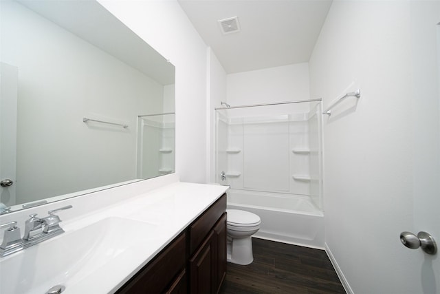 bathroom with toilet, wood finished floors, vanity, visible vents, and shower / bathing tub combination