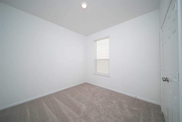 carpeted spare room with baseboards