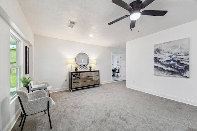 living area featuring a wealth of natural light, carpet, and baseboards