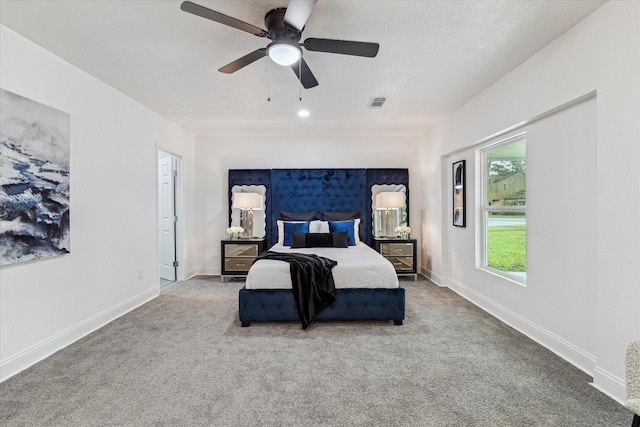 bedroom featuring carpet floors, visible vents, ceiling fan, and baseboards