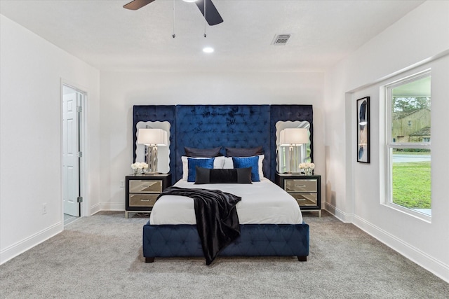 bedroom featuring a ceiling fan, carpet flooring, visible vents, and baseboards