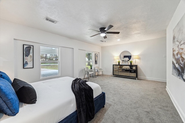 bedroom featuring baseboards, visible vents, ceiling fan, carpet, and a textured ceiling