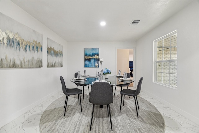 dining area with marble finish floor, visible vents, and baseboards