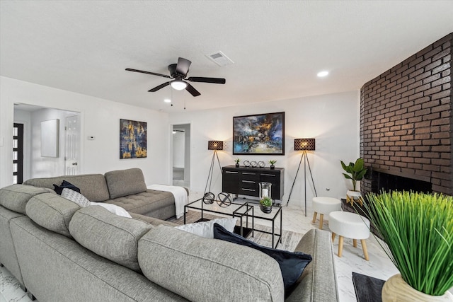 living area featuring visible vents, baseboards, ceiling fan, a fireplace, and recessed lighting