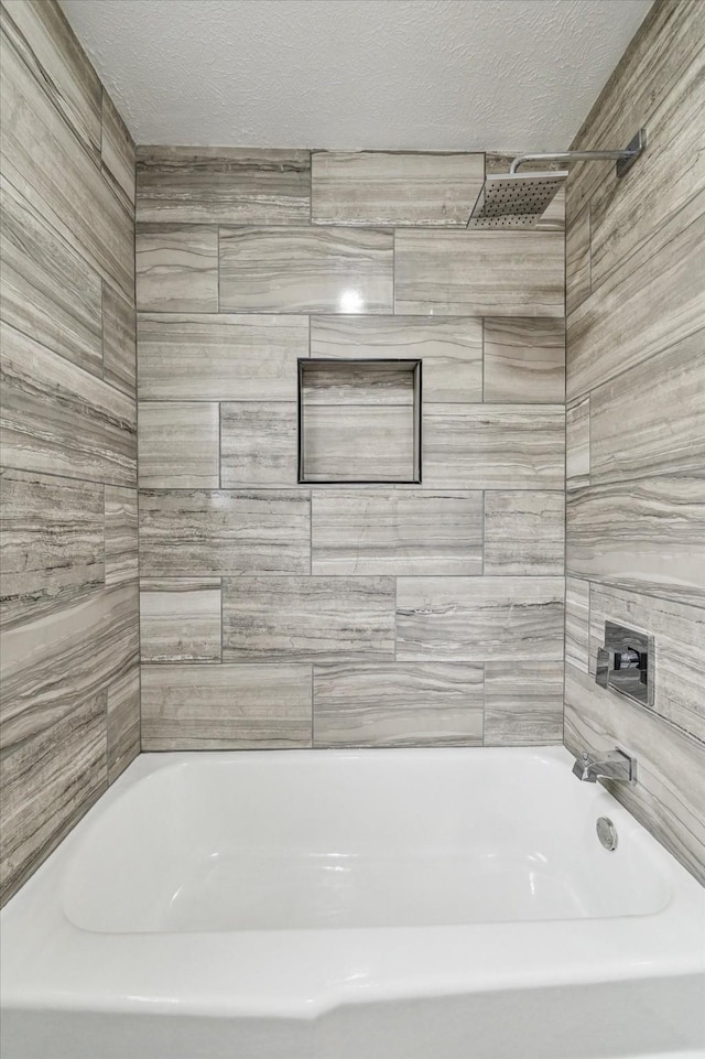 full bathroom with a textured ceiling