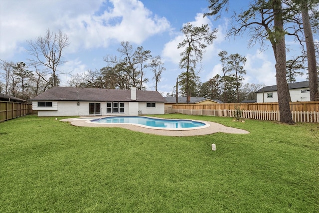 view of pool featuring a yard and a fenced backyard