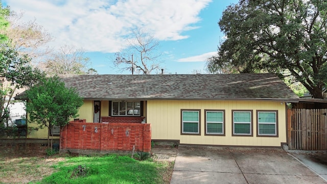 ranch-style house featuring brick siding and a shingled roof