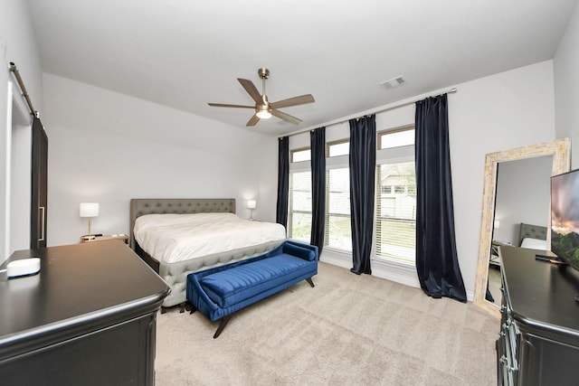 bedroom featuring ceiling fan, visible vents, and light colored carpet