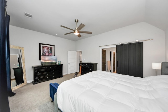 carpeted bedroom with lofted ceiling, visible vents, and a ceiling fan