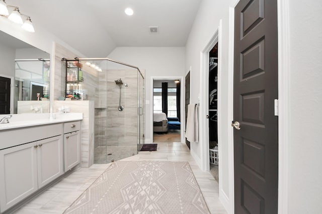 full bath with a stall shower, visible vents, vanity, and a spacious closet