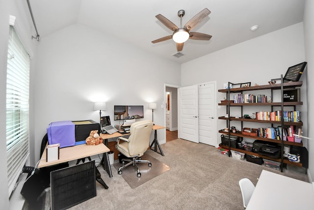 office with lofted ceiling, ceiling fan, visible vents, and carpet flooring