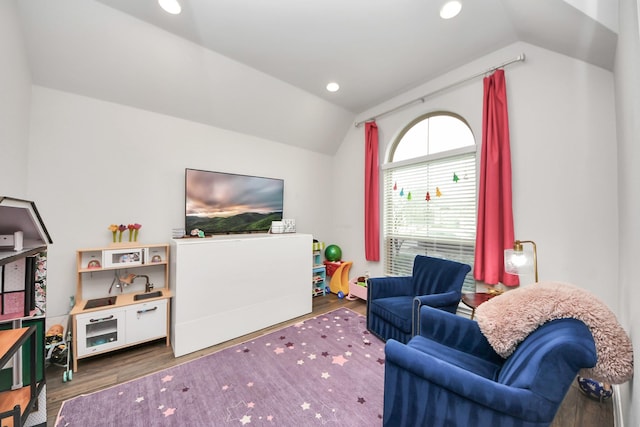 living area with recessed lighting, vaulted ceiling, and wood finished floors